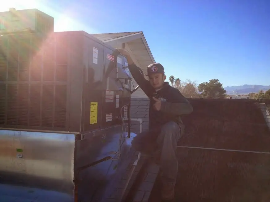 HVAC technician performing HVAC Inspection on a rooftop unit in Lanham